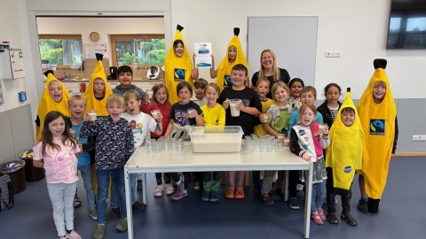 Kinder geben Milchshakes aus in Bananenkostümen